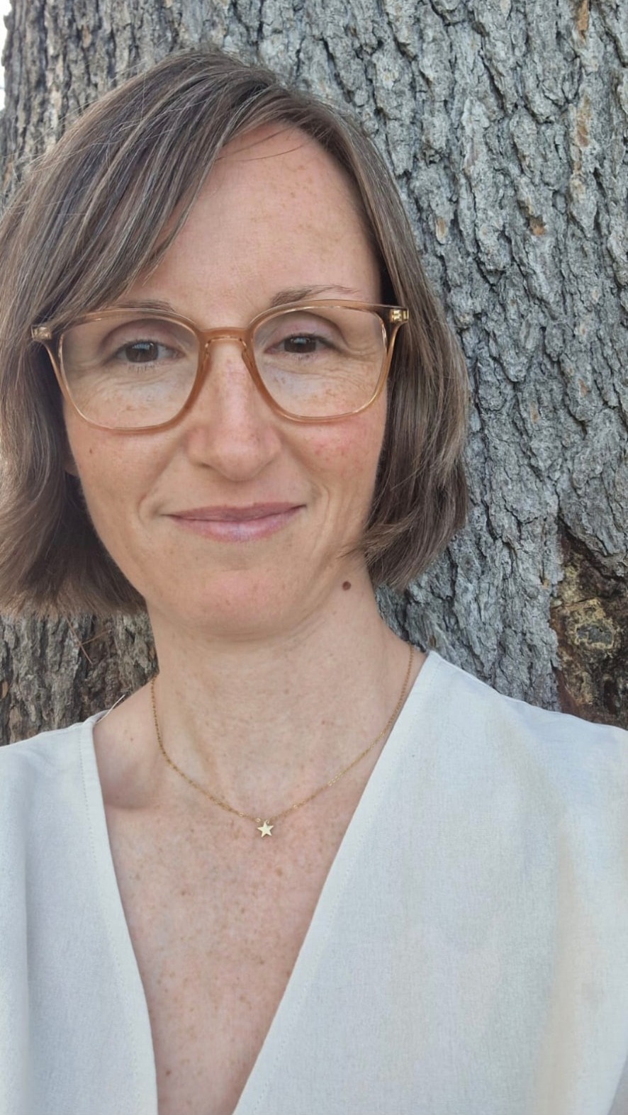 Jessika Weber Sabil smiling in front of a tree