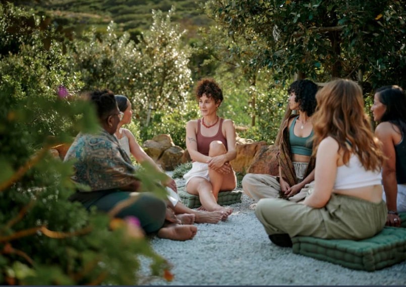 Women sitting together in a garden circle